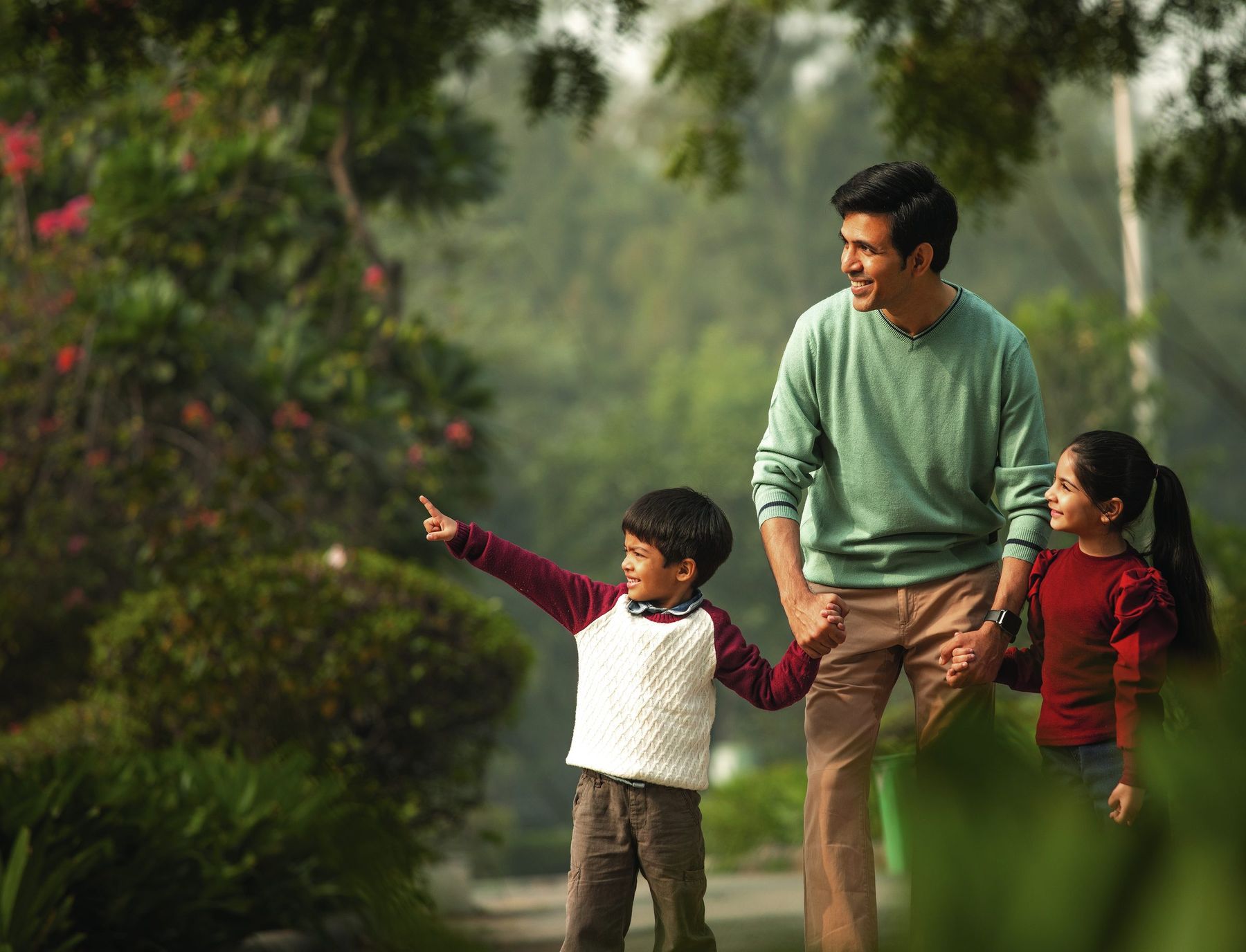 A family walking through the landscaped greens at The Tiara